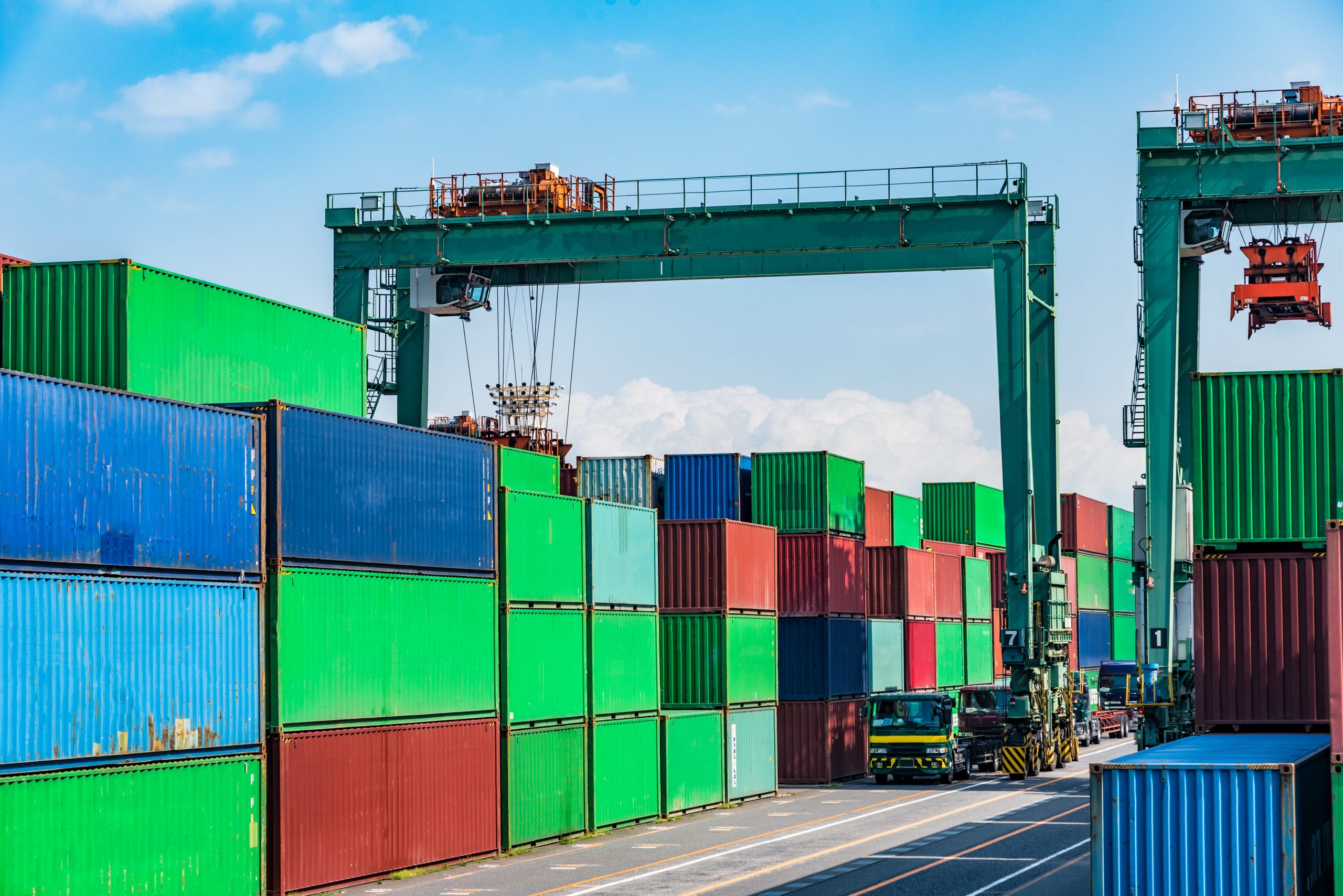 A transport truck loading up drayage supply at a dock full of cargo